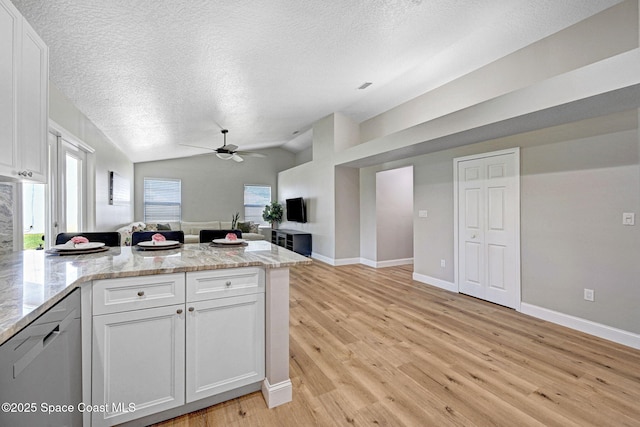 3360 Holly Springs Rd, Melbourne, FL 32934 - kitchen with light wood finished floors, a peninsula, stainless steel dishwasher, a textured ceiling, and a ceiling fan