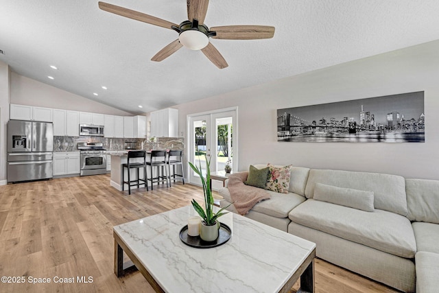 3360 Holly Springs Rd, Melbourne, FL 32934 - living room featuring recessed lighting, light wood finished floors, vaulted ceiling, a textured ceiling, and ceiling fan