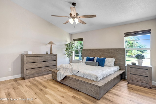 3360 Holly Springs Rd, Melbourne, FL 32934 - bedroom with vaulted ceiling, light wood-type flooring, a ceiling fan, and baseboards