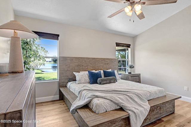 3360 Holly Springs Rd, Melbourne, FL 32934 - bedroom with a ceiling fan, baseboards, light wood-style floors, and a water view