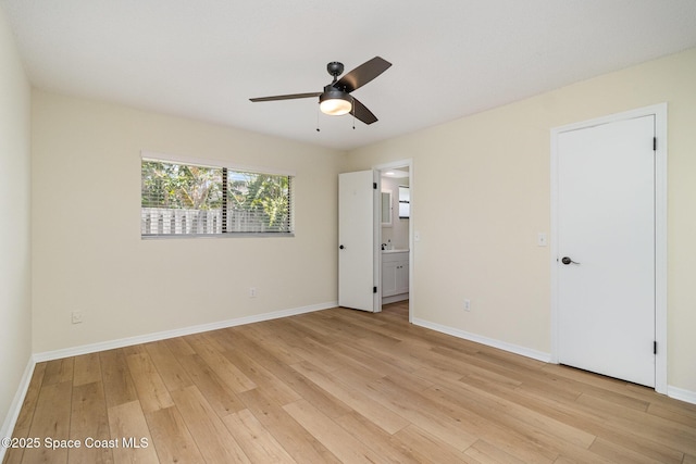 unfurnished bedroom with baseboards, ceiling fan, light wood-style floors, and connected bathroom