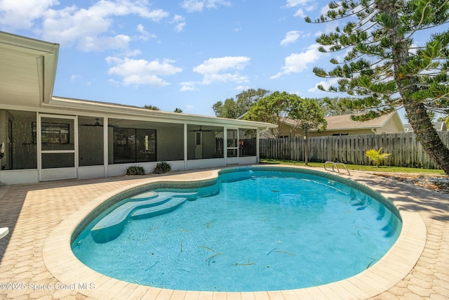 view of pool featuring a fenced in pool, a ceiling fan, a fenced backyard, and a sunroom