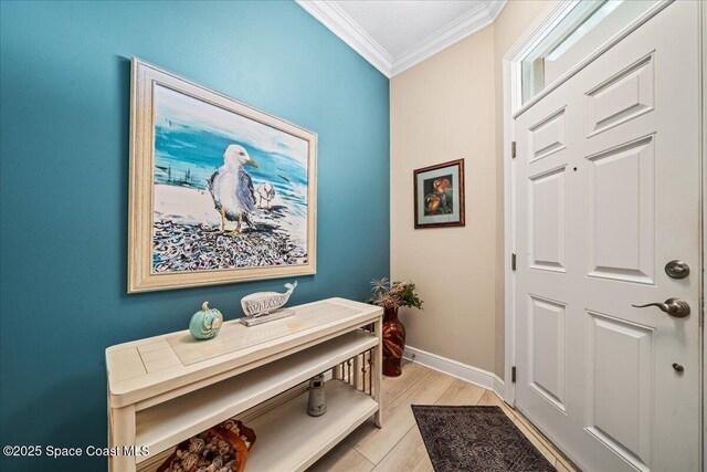 interior space with baseboards, light wood-style floors, and ornamental molding
