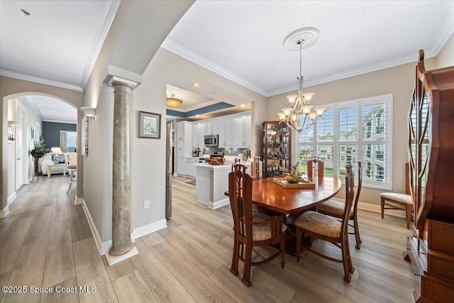 dining space with light wood finished floors, decorative columns, arched walkways, and crown molding