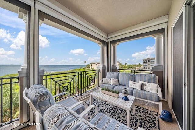 balcony featuring an outdoor hangout area and a water view