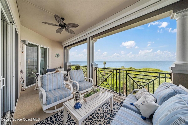 balcony with a water view, ceiling fan, and an outdoor hangout area