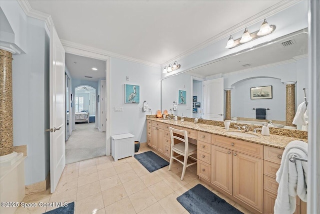 ensuite bathroom with ornate columns, double vanity, visible vents, a sink, and ensuite bathroom