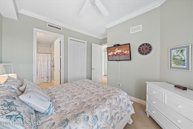 bedroom featuring ensuite bath, visible vents, and ornamental molding