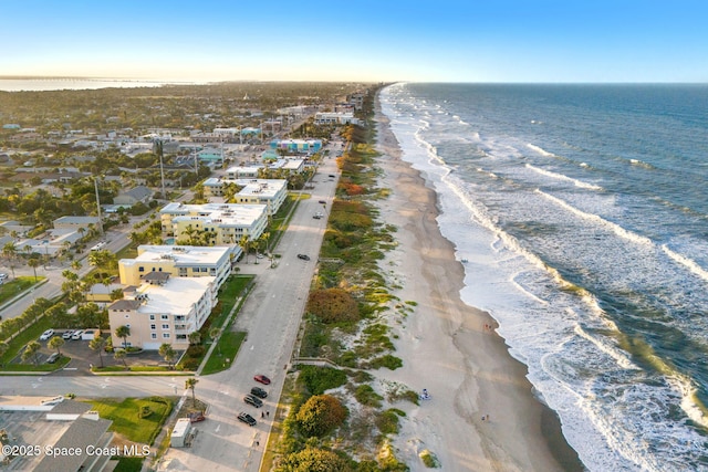 drone / aerial view featuring a view of the beach and a water view