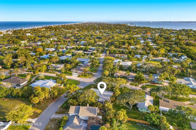 drone / aerial view featuring a water view and a residential view