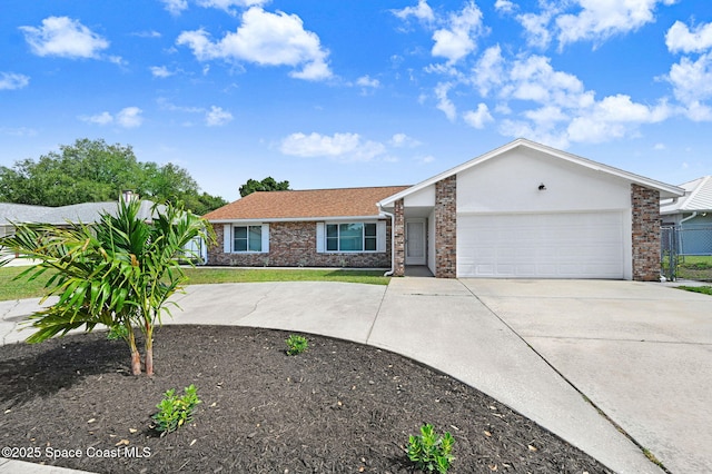 ranch-style house featuring concrete driveway, a garage, and brick siding