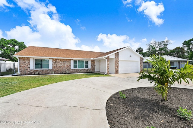ranch-style home with driveway, a front yard, an attached garage, fence, and brick siding
