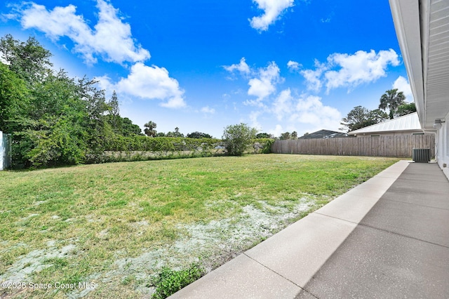 view of yard with fence and central air condition unit