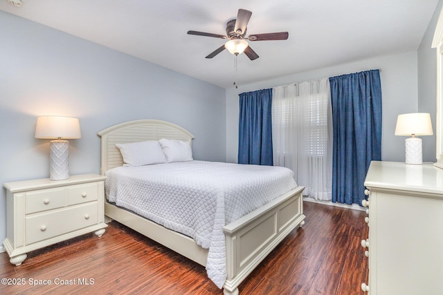 bedroom with a ceiling fan and dark wood-style floors