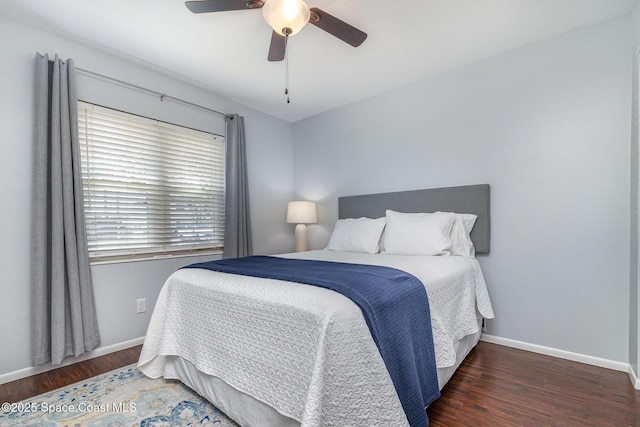 bedroom featuring wood finished floors, baseboards, and ceiling fan