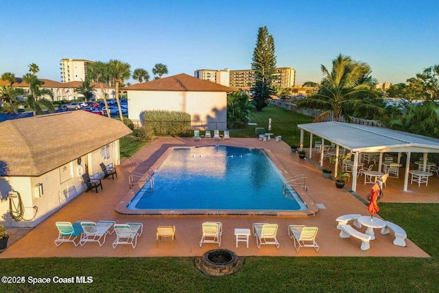 pool with fence, a yard, and a patio