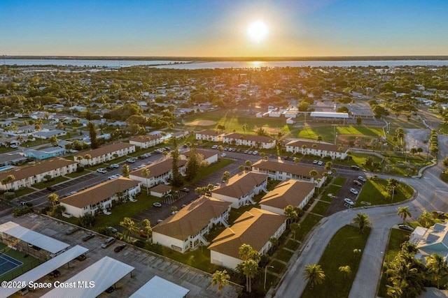 drone / aerial view with a residential view and a water view
