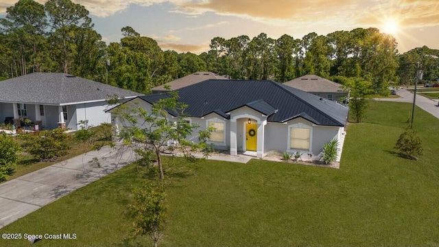 194 Saybrook Rd SW, Palm Bay, FL 32908 - ranch-style house with metal roof, an attached garage, a front lawn, and concrete driveway