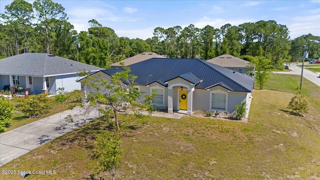 194 Saybrook Rd SW, Palm Bay, FL 32908 - single story home with metal roof, an attached garage, a front lawn, and concrete driveway