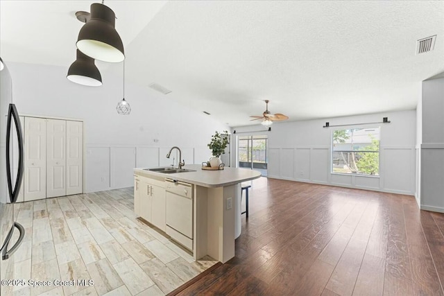 194 Saybrook Rd SW, Palm Bay, FL 32908 - kitchen with dishwasher, visible vents, a sink, light wood-style floors, and ceiling fan