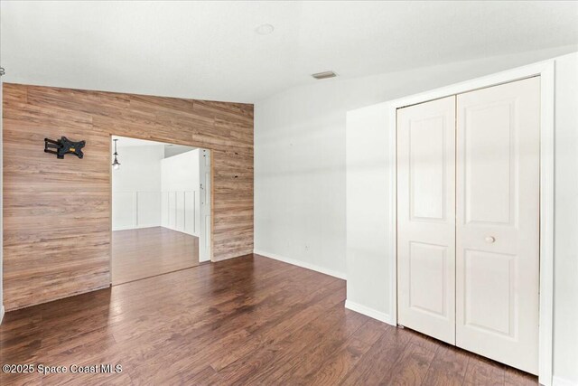 194 Saybrook Rd SW, Palm Bay, FL 32908 - interior space with wood walls, wood finished floors, a closet, baseboards, and visible vents