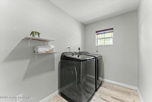 194 Saybrook Rd SW, Palm Bay, FL 32908 - laundry room featuring light wood-style floors, washing machine and clothes dryer, baseboards, and laundry area