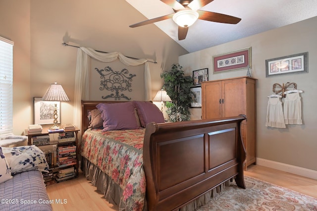 bedroom featuring lofted ceiling, a ceiling fan, light wood finished floors, and baseboards