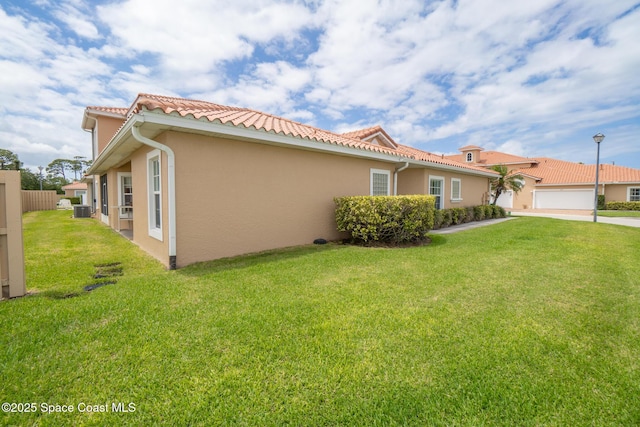 1298 Etruscan Way Unit 119, Indian Harbour Beach, FL 32937 - view of side of property with stucco siding, a tile roof, concrete driveway, and central AC unit