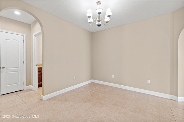 1298 Etruscan Way Unit 119, Indian Harbour Beach, FL 32937 - unfurnished room with arched walkways, light tile patterned floors, a chandelier, and baseboards
