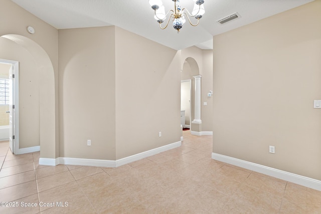 1298 Etruscan Way Unit 119, Indian Harbour Beach, FL 32937 - empty room featuring arched walkways, light tile patterned floors, a chandelier, baseboards, and a smoke detector