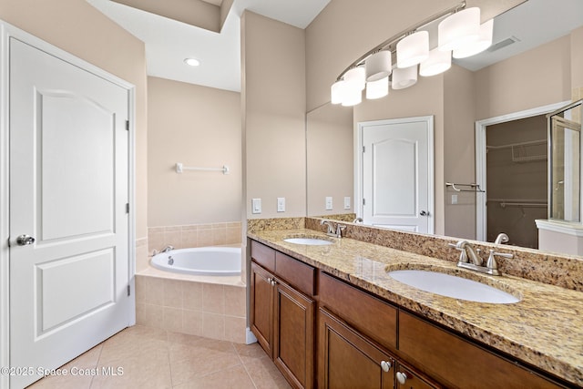 1298 Etruscan Way Unit 119, Indian Harbour Beach, FL 32937 - bathroom with tile patterned floors, a garden tub, double vanity, and a walk in closet