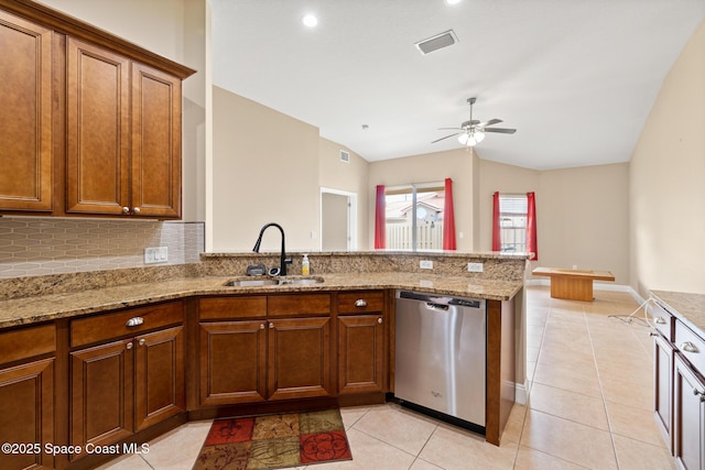 1298 Etruscan Way Unit 119, Indian Harbour Beach, FL 32937 - kitchen featuring a sink, dishwasher, vaulted ceiling, a peninsula, and light tile patterned floors