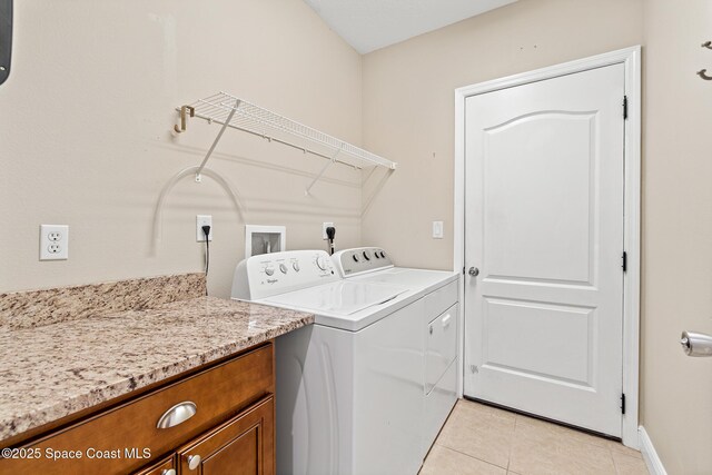 1298 Etruscan Way Unit 119, Indian Harbour Beach, FL 32937 - laundry area featuring washing machine and clothes dryer, light tile patterned flooring, and baseboards