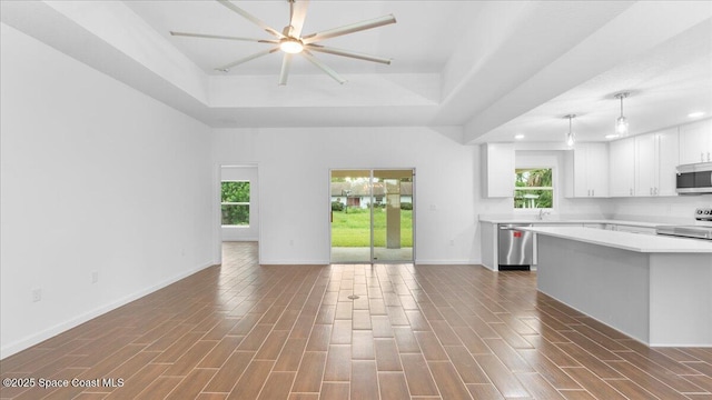 kitchen featuring open floor plan, light countertops, a wealth of natural light, and appliances with stainless steel finishes