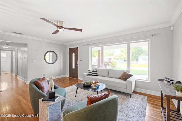 417 E Grant St, Orlando, FL 32806 - living room featuring ornamental molding, wood finished floors, baseboards, and ceiling fan