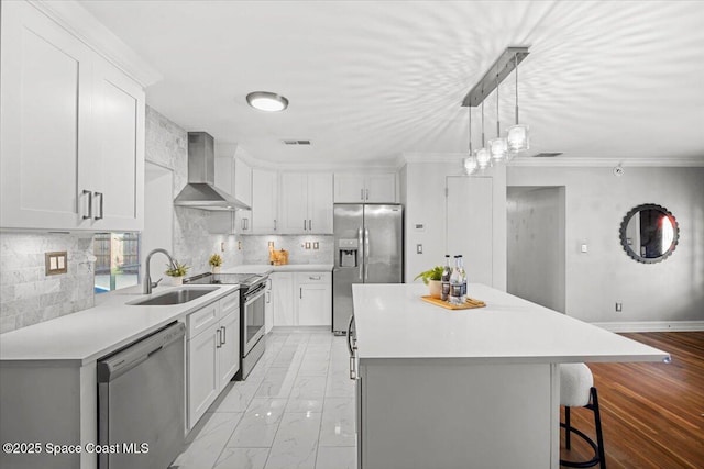 417 E Grant St, Orlando, FL 32806 - kitchen featuring stainless steel appliances, wall chimney range hood, a sink, a center island, and a breakfast bar area