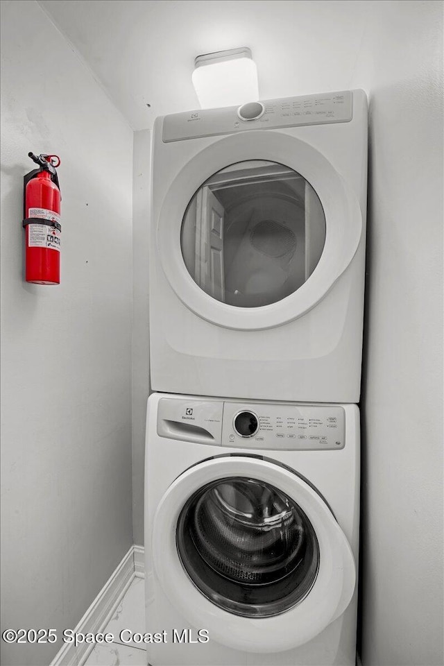 417 E Grant St, Orlando, FL 32806 - laundry area with estacked washer and dryer and baseboards