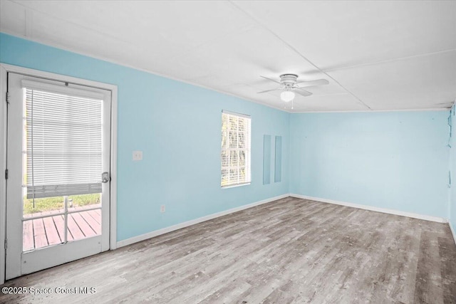 417 E Grant St, Orlando, FL 32806 - empty room with a ceiling fan, wood finished floors, and baseboards