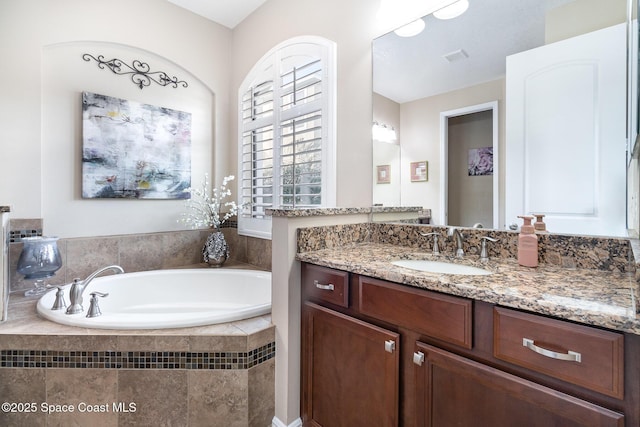 full bath featuring a bath and vanity