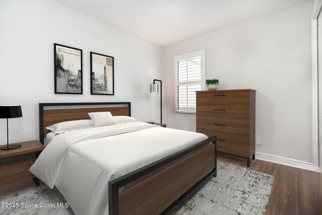 bedroom featuring baseboards and wood finished floors