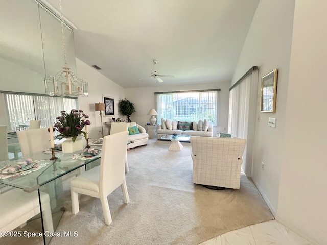 interior space with ceiling fan with notable chandelier, baseboards, vaulted ceiling, and visible vents