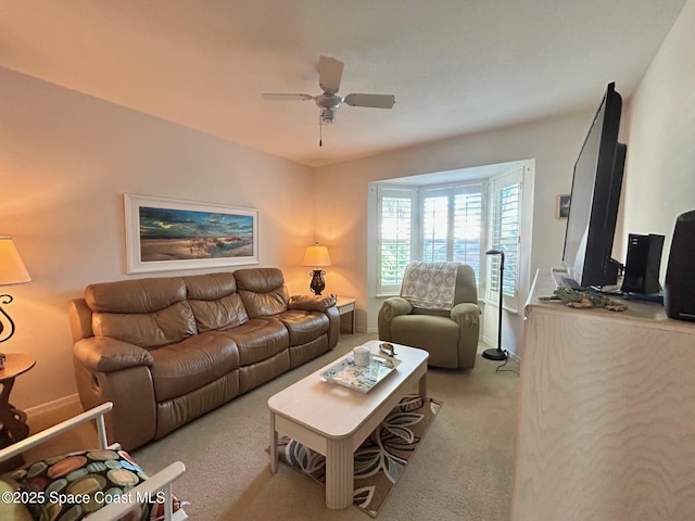 carpeted living room with a ceiling fan