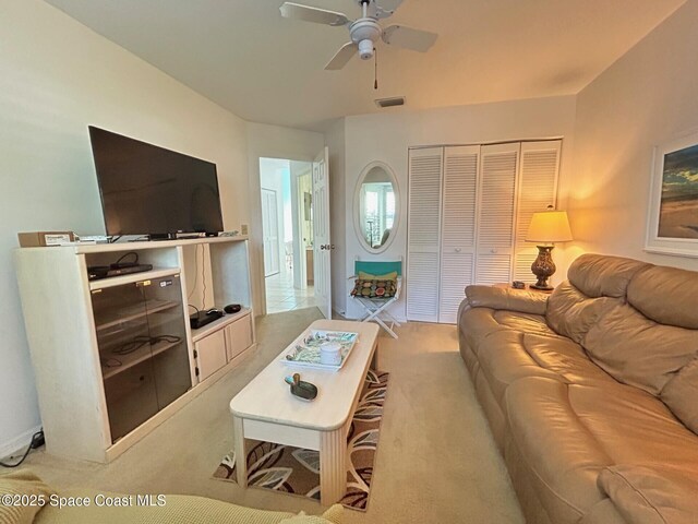 carpeted living area featuring visible vents and ceiling fan