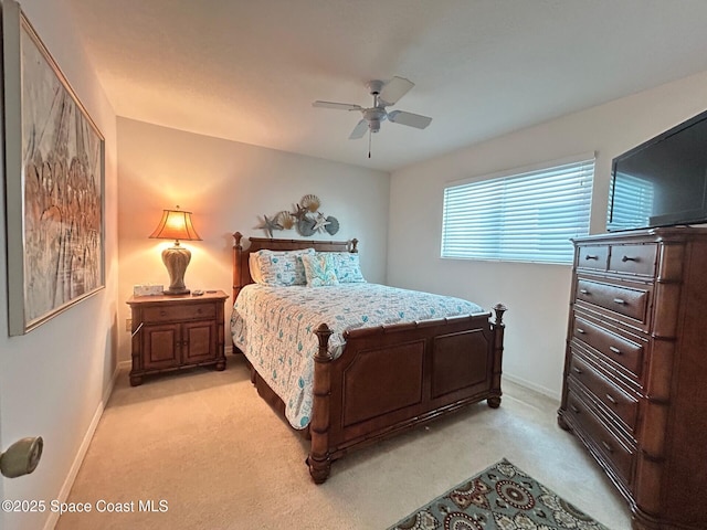 bedroom featuring baseboards, a ceiling fan, and light colored carpet
