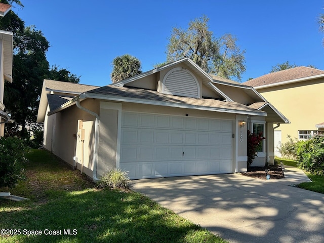 view of front of home with a shingled roof, concrete driveway, stucco siding, and a garage