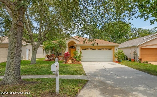 7016 Hammock Trace Dr, Melbourne, FL 32940 - ranch-style house with stucco siding, concrete driveway, a garage, and a front lawn