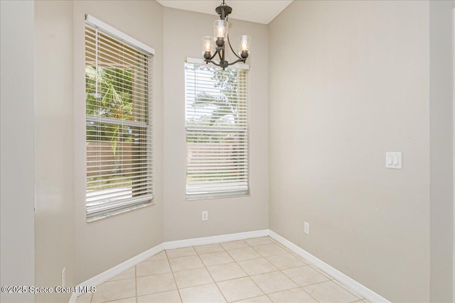 7016 Hammock Trace Dr, Melbourne, FL 32940 - unfurnished room with a chandelier, baseboards, and light tile patterned floors