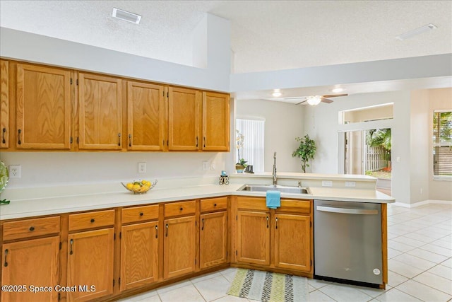 7016 Hammock Trace Dr, Melbourne, FL 32940 - kitchen featuring stainless steel dishwasher, a sink, a peninsula, and brown cabinets