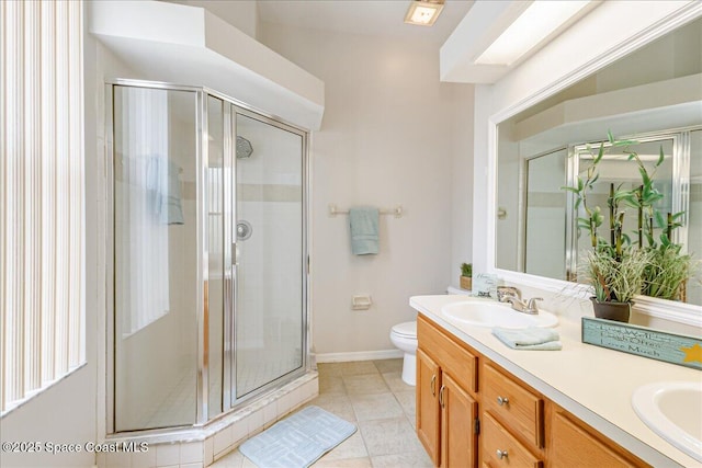 7016 Hammock Trace Dr, Melbourne, FL 32940 - bathroom with double vanity, a shower stall, toilet, tile patterned floors, and baseboards