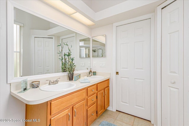 7016 Hammock Trace Dr, Melbourne, FL 32940 - bathroom featuring double vanity, a closet, and tile patterned floors